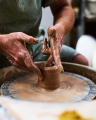 close up man working on a pottery wheel