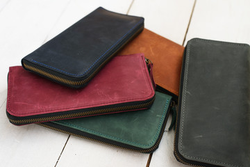 vintage wallet of different colors on a wooden background