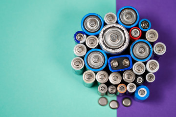 Many different types used or new battery, rechargeable accumulator, alkaline batteries on color...