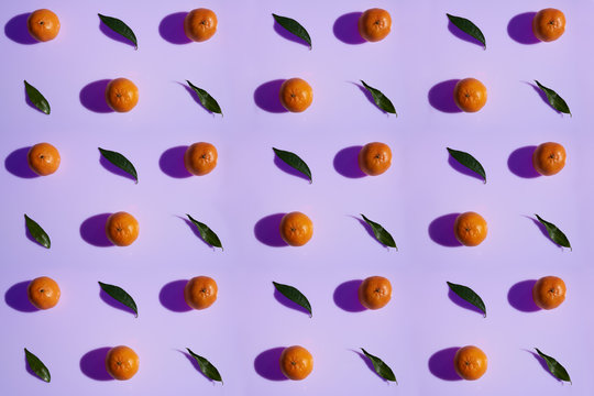 Tangerine pattern with leaves on a violet color background in high resolution
