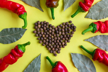 The heart symbol from the pepper. Bay leaf and red pepper. Fragrant and aromatic seasonings. Beautiful bright background