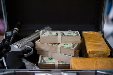 Drug trafficker holding a lot of cash on hand and use gun pushing drugs to the customer in the Drug...