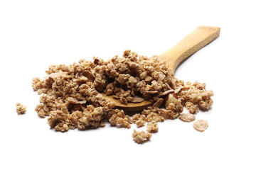 Crunchy granola, muesli pile with nuts in wooden spoon isolated on white background