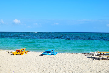 Fototapeta na wymiar sandy beach with chairs, Grand Bahama Island