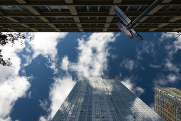 Skyscraper facade with the sky and clouds reflected on the windows. Manhattan, New York city, Usa.