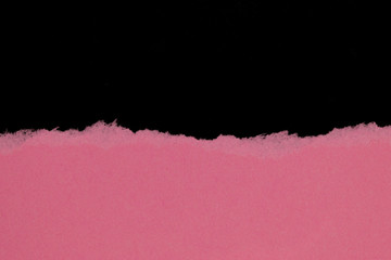 Pink ripped paper isolated on black background with copy space