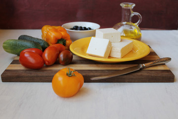 ingredients for the greece salad on the cutting board