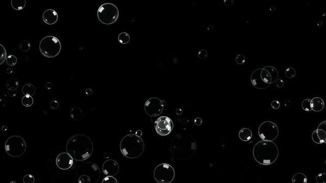 A field full of grey soap bubbles floating around, appearing and disappearing with a pop. Black background.

