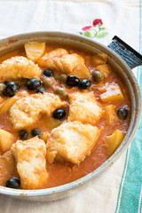 Salted cod stewed with olives