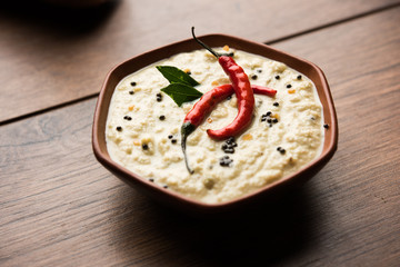 Nariyal or Coconut Chutney served in a bowl. Isolated over moody background. selective focus