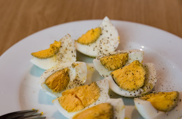 Boiled eggs with salt pepper and olive oil