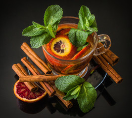 spices; cinnamon, mint, red orange, glass Cup on a saucer