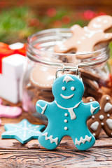 Colorful Christmas cookies in a jar and wooden table