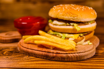 Hamburger and sauce on a wooden table
