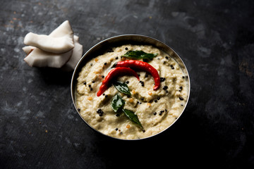 Nariyal or Coconut Chutney served in a bowl. Isolated over moody background. selective focus