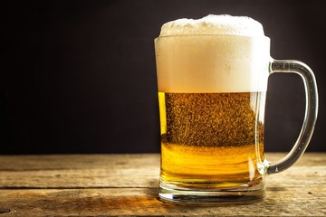 Glass of beer on a black background. Sales of alcohol. Beer in a glass. Czech beer.