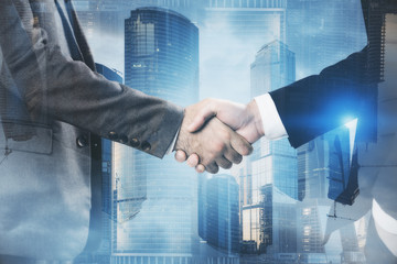 Men shake hands in blue Moscow city