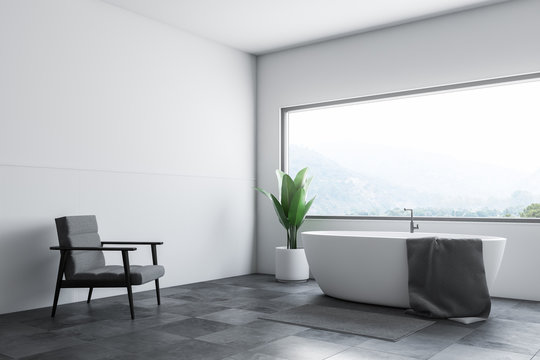 White bathroom corner tub and armchair