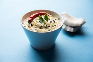 Nariyal or Coconut Chutney served in a bowl. Isolated over moody background. selective focus