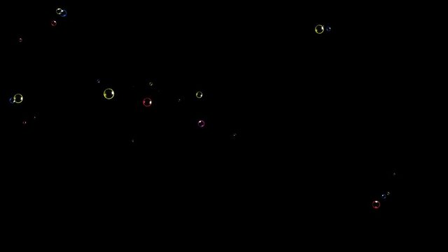 Colorful tiny soap bubbles appearing at random locations on a black background, disappearing with a pop.
