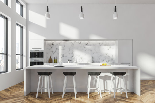 White and marble kitchen interior with bar