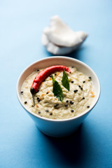 Nariyal or Coconut Chutney served in a bowl. Isolated over moody background. selective focus