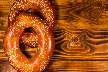 Bagels with sesame seeds on wooden table. Top view