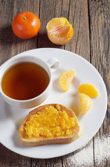 Tea and toasted bread with tangerine jam