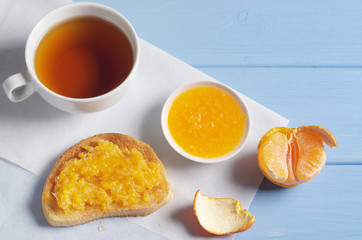 Tea and toasted bread with mandarins jam