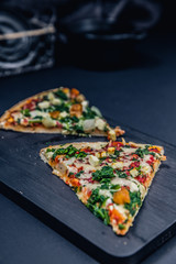 Tasty pizza with spinach and ingredients on a background. Top view