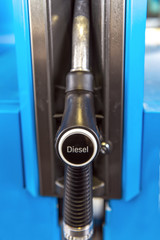 A petrol nozzle with the inscription Diesel hangs in the petrol pump. Front view. Concept: diesel scandal or refueling