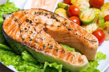 Grilled salmon with brussels sprouts and tomatoes. Close-up, selective focus.