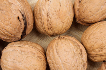 Many walnuts on a wooden background