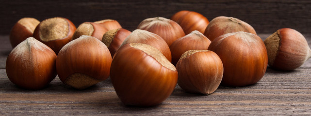 Handful of hazelnuts on wooden background