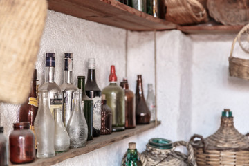 Set of vintage old bottles placed on a ledge of a kitchen