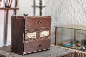 Antique and vintage wooden box on a table full of dust