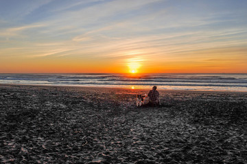 Man With His Dog At Sunset
