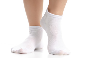 Female legs in white socks on white background. Isolation