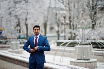 Elegant indian fashionable man model on suit posed at winter day.