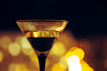 martini on the background of the night city. Bokeh