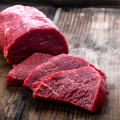 Fresh beef steak sliced on a background