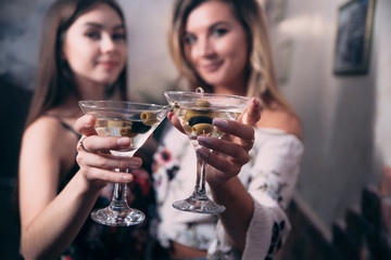 Girls with glasses of white wine in a nightclub