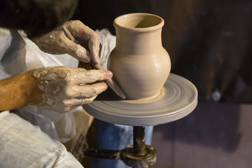 The potter works on the potter's wheel