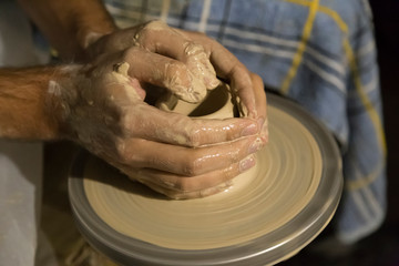 The potter works on the potter's wheel