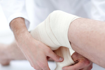 closeup. doctor bandaging a patient's leg
