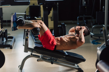 Strong man in the gym doing abs exercises
