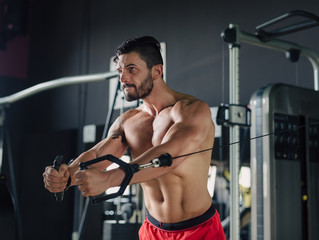 Fototapeta na wymiar Strong man in the gym doing chest exercises