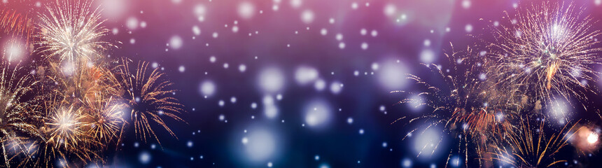 Colorful fireworks background with falling snow at night and with free space for text