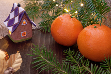 Tangerines and ornaments with christmas lights and fir branches - 238956616