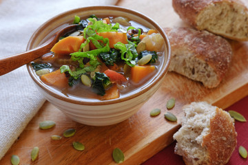 Vegetable soup in ceramic bowl with bread - 238956637